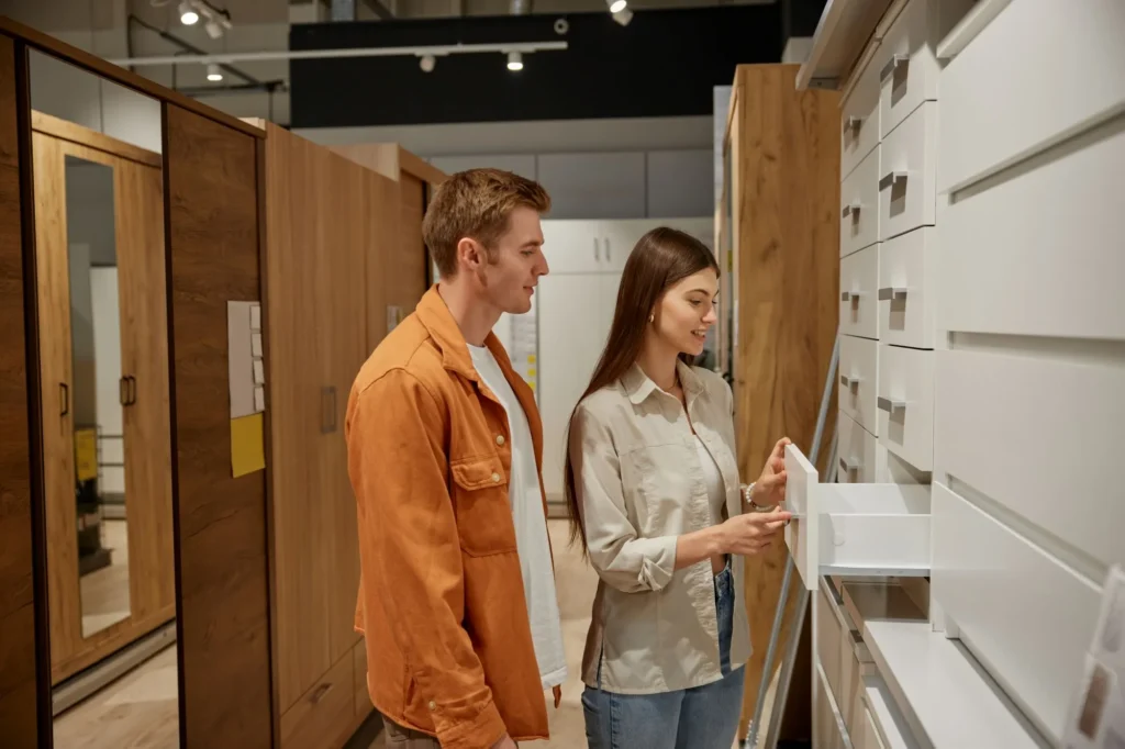Current image: Designer reviewing plans for a custom cabinetry project in Edmonton